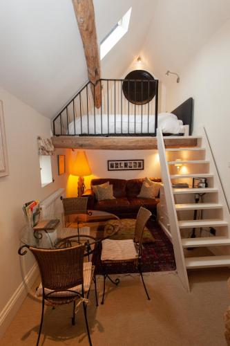 a room with a loft with a bed and a staircase at Popfosters Barn in Weston Subedge