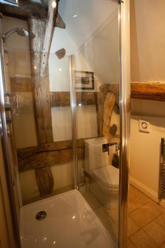 a bathroom with a shower and a toilet at Popfosters Barn in Weston Subedge