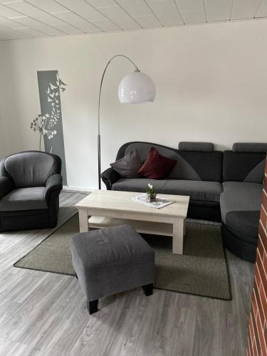 a living room with a couch and a coffee table at Harzer Ferienlodge in Wernigerode