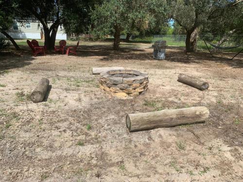 a fire pit in a park with logs on the ground at The Perfect Get Away !!!! in Clewiston