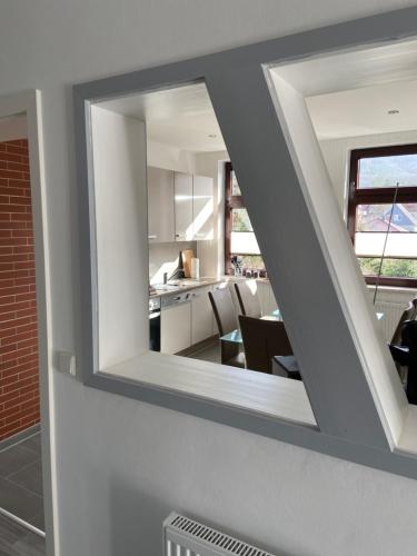 a mirror on the side of a room with a kitchen at Harzer Ferienlodge in Wernigerode