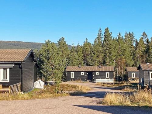 a row of houses with trees in the background at 4 person holiday home in S LEN in Sälen