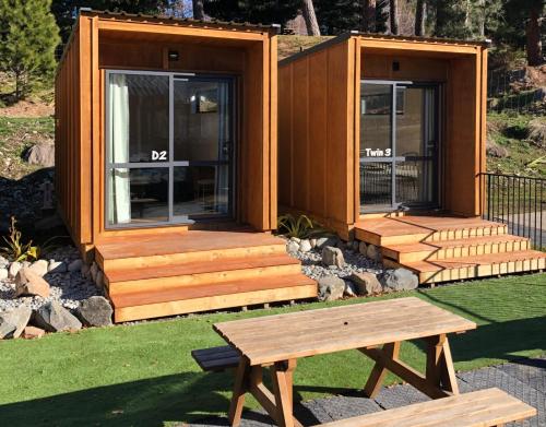 a tiny house with a picnic table in front of it at Lakes Edge Lodge in Lake Tekapo