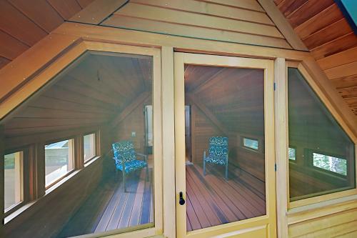 a screened in porch of a house with two chairs at Lazy Lumberjack Grande in Franklin