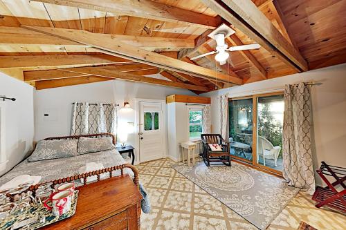 a bedroom with a bed and a wooden ceiling at Atlantic Gardens in Boothbay Harbor