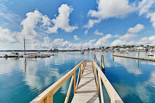 a dock with boats in a marina on the water at Atlantic Gardens in Boothbay Harbor