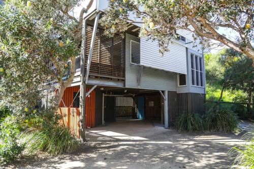 a house with a ramp leading to a garage at BEST OCEAN VIEWS ON STRADDIE + SUNSET DECK in Point Lookout