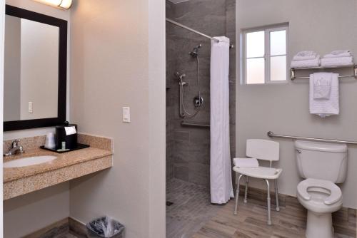 a bathroom with a shower and a toilet and a sink at Best Western Kettleman City Inn & Suites in Kettleman City
