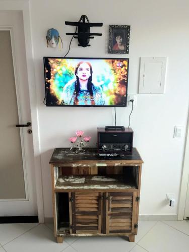 a flat screen tv on a wall in a room at Pousada Souza in Florianópolis