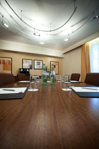 a conference room with a large table with bottles on it at Radisson Blu Hotel Karlsruhe in Ettlingen