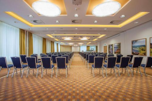a large room with rows of chairs in it at Radisson Blu Hotel Karlsruhe in Ettlingen