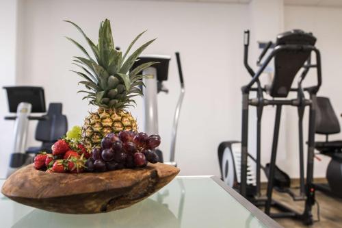 a bowl of fruit sitting on top of a table at Radisson Blu Hotel Karlsruhe in Ettlingen