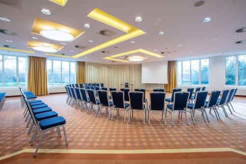 a conference room with chairs and a podium at Radisson Blu Hotel Karlsruhe in Ettlingen