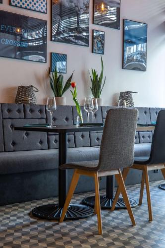 a table and chairs in a room with a couch at Park Inn by Radisson Poznan in Poznań