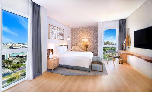 a hotel room with a bed and a large window at Radisson Blu Hotel & Resort, Abu Dhabi Corniche in Abu Dhabi