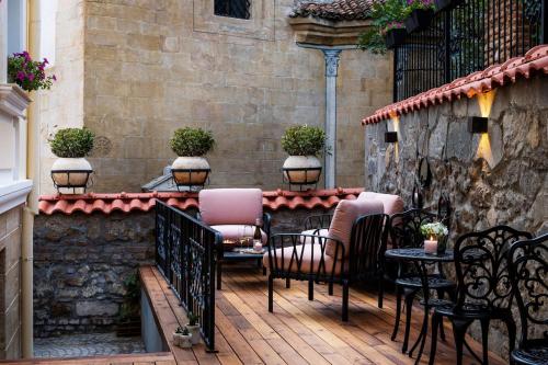 a patio with chairs and tables on a building at Gallery 37 Powered by ASTON in Plovdiv