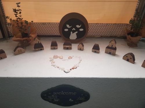 a heart made out of beads on a table with houses at Sokcho & Guesthouse in Sokcho