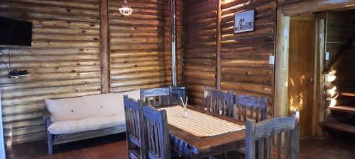 a dining room with a table and chairs and a couch at Mirador de Montaña in Ciudad Lujan de Cuyo