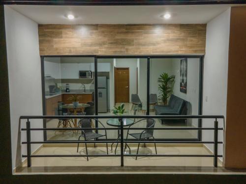 a living room with a balcony with a table at Hermoso departamento con alberca, a 10 minutos de la playa!!! in Mazatlán