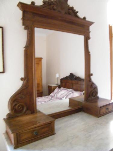 a large mirror in a bedroom with a bed at B&B Il Glicine in Montefollonico
