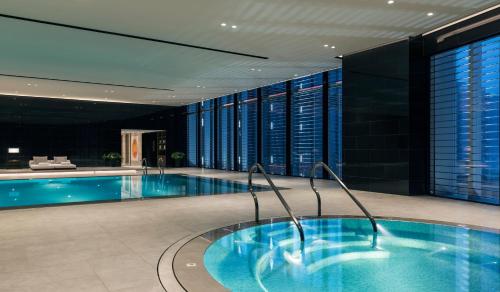 a large swimming pool in a hotel lobby with a pool at Niccolo Changsha in Changsha