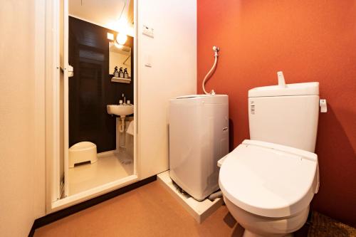 a bathroom with a white toilet and a shower at Apartment Sunbright in Tokyo