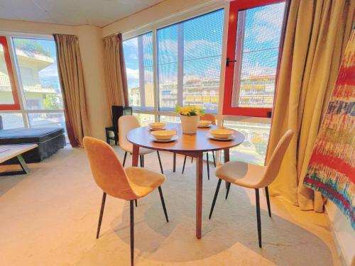 a table and chairs in a room with a window at WSD Baia Acropolis Hotel Apartment in Athens
