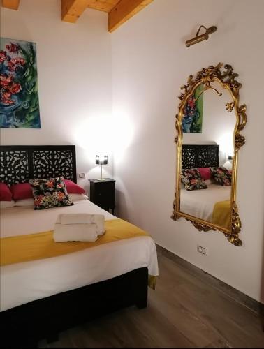 a bedroom with a bed and a mirror at Casa Busari in Palermo