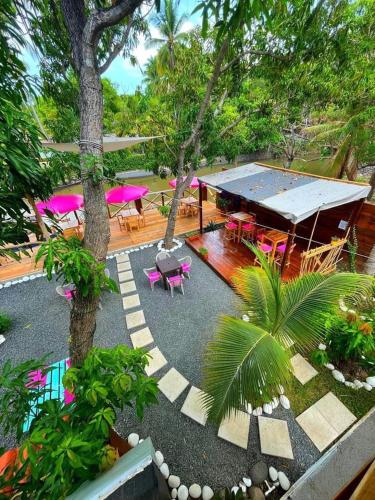 an aerial view of a patio with tables and chairs at The Beach Break Hotel El Zonte in El Zonte