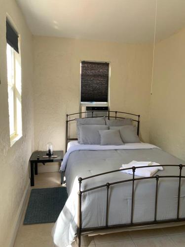 a bedroom with a large bed and a table at Cute Private Room - Close to airport & Free parking 01 in Miami