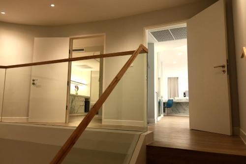 a staircase leading to a room with a living room at VELA Dhi Udon Thani in Udon Thani