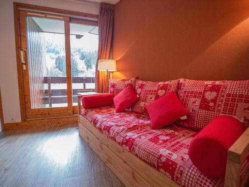 ヴァルモレルにあるAppartement Valmorel, 3 pièces, 6 personnes - FR-1-356-316の窓付きの客室で、ソファ(赤い枕付)