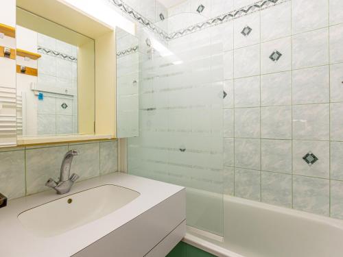 a bathroom with a tub and a sink and a mirror at Appartement La Plagne, 1 pièce, 4 personnes - FR-1-353-77 in La Plagne