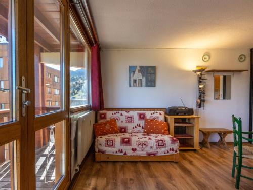 a living room with a couch and a window at Appartement La Plagne, 2 pièces, 4 personnes - FR-1-351-80 in La Plagne