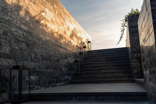 a set of stairs next to a brick building at Ramada Plaza by Wyndham Chao Fah Phuket in Phuket Town