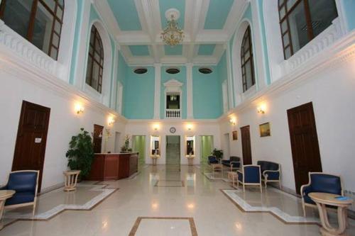 a large hallway with chairs and tables in a building at President-hotel Tavrida in Yalta