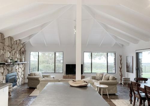 a living room with a couch and a table at Yungarra Estate in Dunsborough