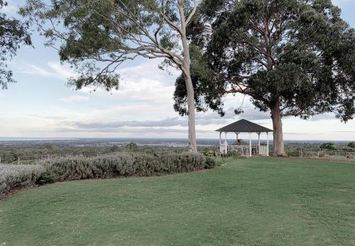 a gazebo in a field with trees and grass at Yungarra Estate in Dunsborough