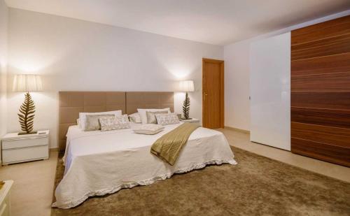 a bedroom with a large bed and a large closet at Luxury Beachfront Villa Palazzo di Mare with private heated pool and staff at the beach on Brac island - Sumartin in Selca