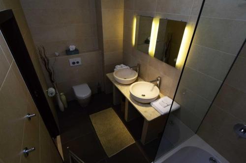 a small bathroom with two sinks and a mirror at Luxury Beachfront Villa Palazzo di Mare with private heated pool and staff at the beach on Brac island - Sumartin in Selca