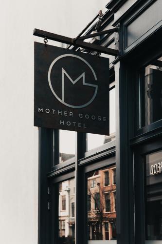 a sign for a hotel in front of a window at Mother Goose Hotel in Utrecht