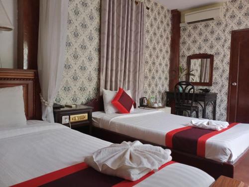 Ein Bett oder Betten in einem Zimmer der Unterkunft Vimean Sovannaphoum Resort