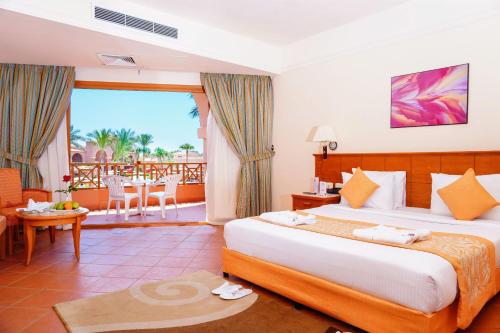 a hotel room with a bed and a balcony at Charmillion Gardens Aquapark in Sharm El Sheikh
