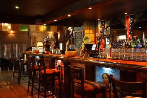 a bar with a lot of bar stools at Smith And Western in Royal Tunbridge Wells