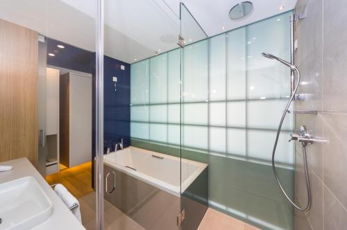 a bathroom with a shower and a sink at D-Resort Šibenik in Šibenik