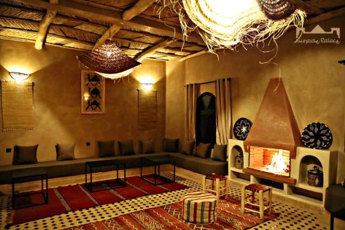 a living room with a couch and a fireplace at Sunrise Palace Merzouga in Merzouga