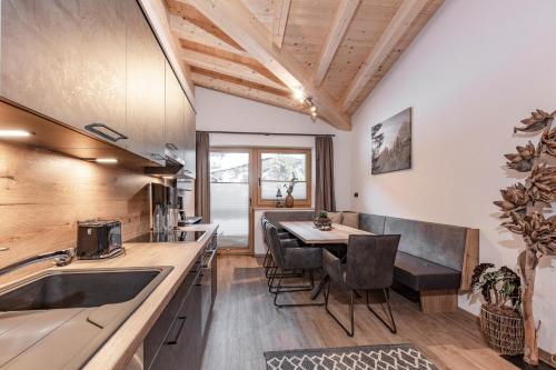 a kitchen with a table and a dining room at Landhaus Sonnenwiese in Sölden