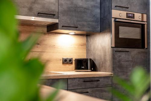 a kitchen with a toaster oven and a microwave at Landhaus Sonnenwiese in Sölden