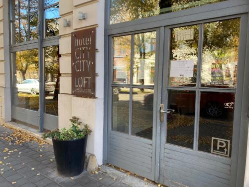 a store door with a sign in front of it at Hotel city.city in Ostrava