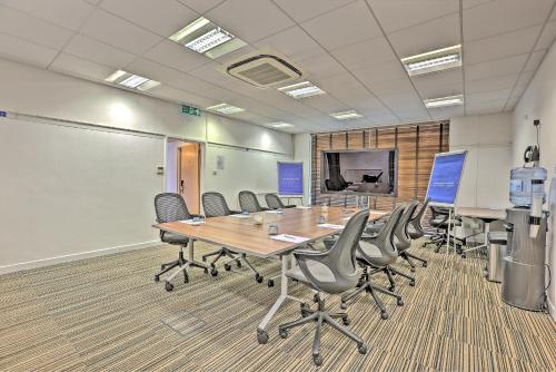 a conference room with a long table and chairs at Hartsfield Manor in Dorking